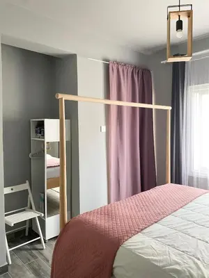 a bedroom with a bed and a mirror at Cheerful Apartment in Nicosia in Yukarı Lakatamya