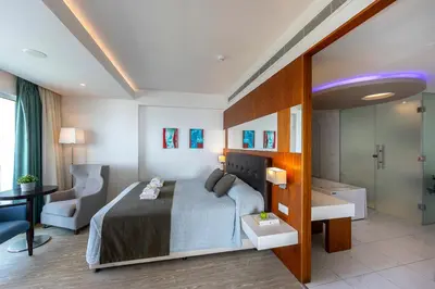 a hotel room with a bed and a bathroom at Melissi Beach Hotel & Spa in Ayia Napa