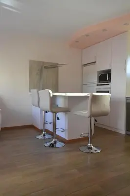 a kitchen with two chairs and a table in a room at Двуспальная квартира возле дасуди in Limassol