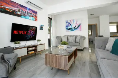 a living room with a couch and a coffee table at Villa Calliopi in Protaras