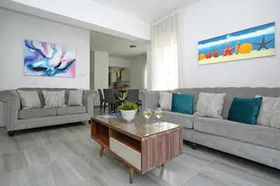 a living room with a couch and a table at Villa Calliopi in Protaras