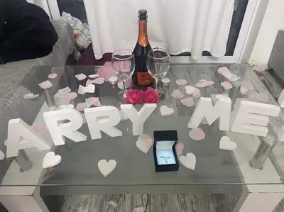 a glass table with a bottle of champagne and wine glasses at Hermes complex1 paralimni in Paralimni