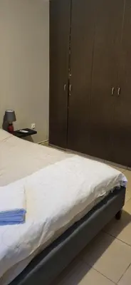 a bedroom with a bed and cabinets in it at Hermes complex1 paralimni in Paralimni