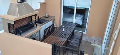 a balcony with a stove and a kitchen with a fireplace at Hermes Complex 2 Paralimni Cyprus in Paralimni