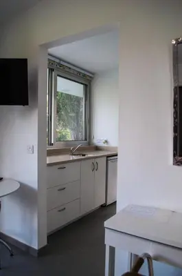 a kitchen with a sink and a window at Idyllic studio with private pool in Nicosia