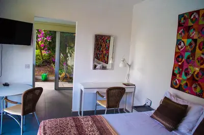 a bedroom with a bed and a table and chairs at Idyllic studio with private pool in Nicosia