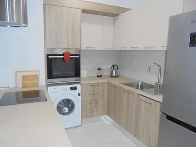 a kitchen with a washing machine and a dishwasher at Kermia Court - Beach-front, modern 2 bedroom -sleeps 6 in Limassol