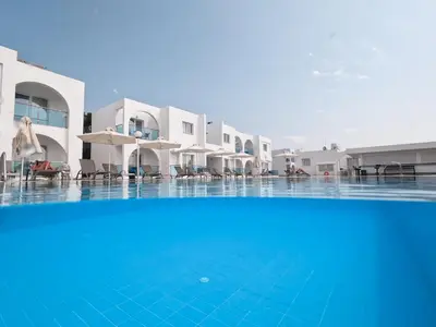 a large swimming pool in front of a hotel at Kaos Hotel Apartments in Ayia Napa