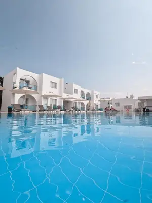 a large swimming pool in front of a building at Kaos Hotel Apartments in Ayia Napa