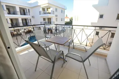 a balcony with chairs and a table on a balcony at Carisa Livadia Gardens in Livadhia