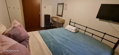a bedroom with a bed and a flat screen tv at Petro's Antique House in Nicosia