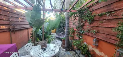 a patio with a table and chairs in a garden at Petro's Antique House in Nicosia