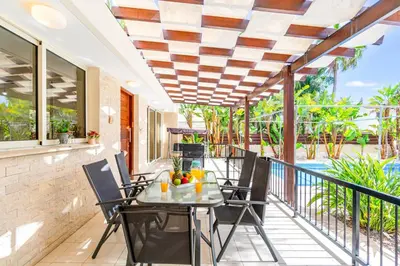 a patio with a table and chairs on a balcony at Villa Venus by Ezoria Villas in Pervolia