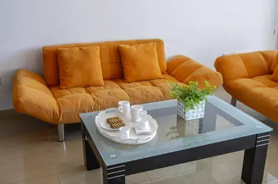 a living room with a couch and a coffee table at one bedroom apartment in Fig tree bay in Protaras