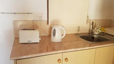 a kitchen counter with a toaster and a sink at ZORBAS Sea View No 4 in Larnaka