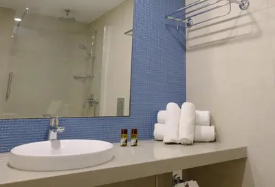 a bathroom with a sink and a mirror at Sunrise Oasis Hotel & Waterpark in Protaras