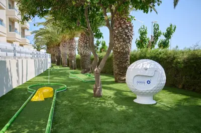 a garden with a toilet on the grass with trees at Sunrise Oasis Hotel & Waterpark in Protaras