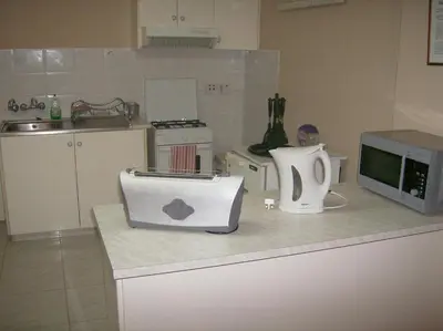 a kitchen with a microwave and a toaster on a counter at Rantzo Holiday Apartments in Pissouri