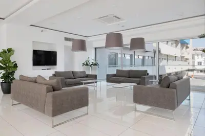 a living room with two couches and a tv at UC Hall Residence in Nicosia