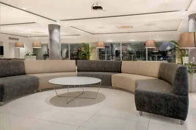 a waiting room with couches and a table at UC Hall Residence in Nicosia