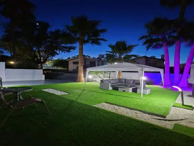 a gazebo on a lawn at night at 3 Bedroom Villa, private pool, hot tub in Protaras