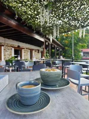 two bowls of coffee sitting on a table at Two Flowers Hotel in Pedoulas