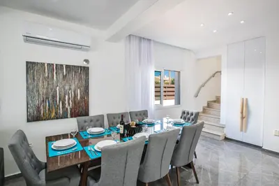 a dining room with a table and chairs at Marimar villa in Protaras
