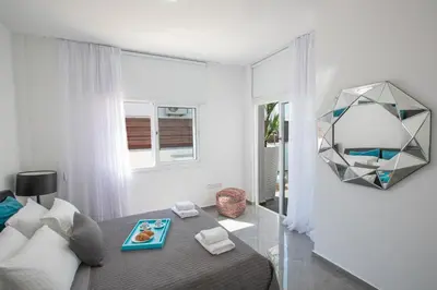 a bedroom with a bed with a tray of food on it at Marimar villa in Protaras