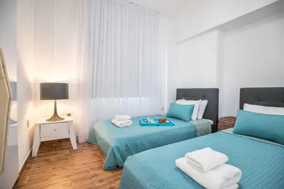 two beds in a room with blue and white at Marimar villa in Protaras