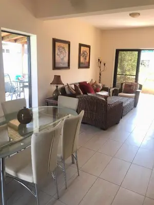 a living room with a glass table and a couch at Limni Pool House B in Larnaka