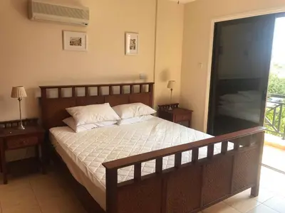 a bedroom with a large bed with two night stands at Limni Pool House B in Larnaka