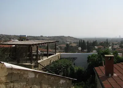 a view of a house with a roof at Dolphin Guest House and Studios in Tochni