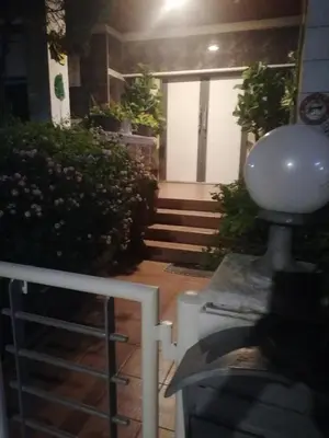 a building with a white door and some stairs at Andros Residence in Limassol