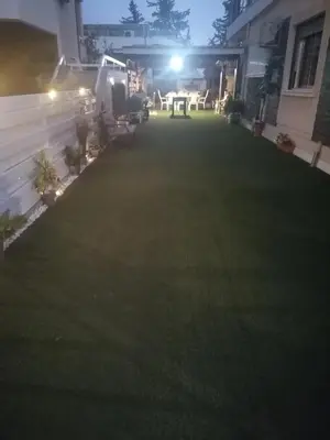 a backyard at night with a lawn at Andros Residence in Limassol
