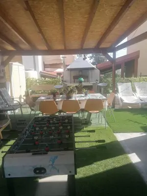 a patio with a table and chairs under a roof at Andros Residence in Limassol