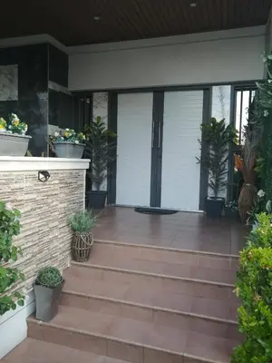 a patio with potted plants on a house at Andros Residence in Limassol