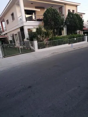a building with a fence on the side of a street at Andros Residence in Limassol