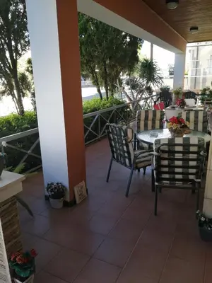 a patio with a table and chairs on a balcony at Andros Residence in Limassol