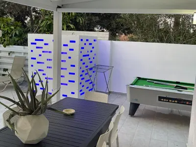 a patio with a ping pong table and a ping pong ball at Konnos Hight Villa in Protaras