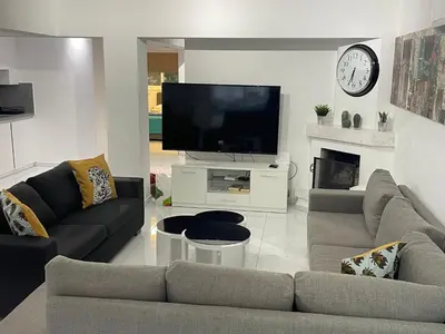 a living room with a couch and a tv at Konnos Hight Villa in Protaras