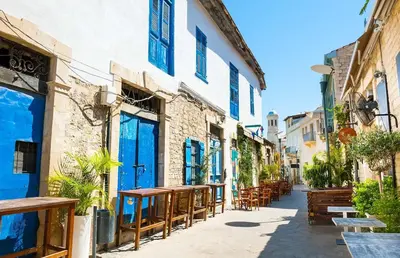 a street with tables and benches in an alley at Delphi Court - large 1 bed -sleeps 4, Near sea/beach - free wifi in Limassol