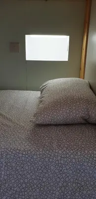 a bedroom with a bed with a pillow and a window at NEX Hostel in Nicosia