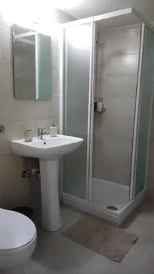 a bathroom with a sink and a shower at LCA4 flat for you apartment in Larnaka