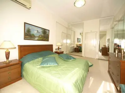 a bedroom with a green bed with two pillows at Patatas Villa in Limassol