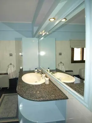 a bathroom with two sinks and a large mirror at Patatas Villa in Limassol