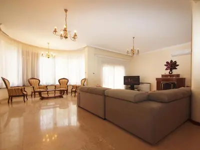 a living room with a couch and a table at Patatas Villa in Limassol