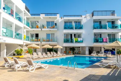 a hotel with a swimming pool and chairs and a building at A Maos Hotel Apartments in Ayia Napa