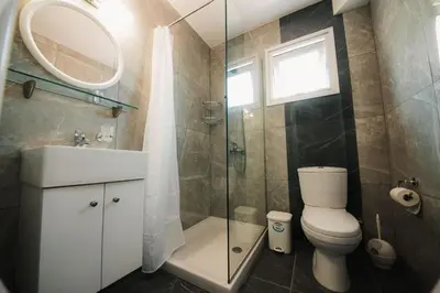 a bathroom with a toilet and a sink and a shower at A Maos Hotel Apartments in Ayia Napa