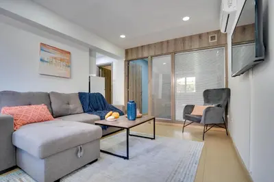 a living room with a couch and a table at Atlantis Apartments 50m from Makenzy seafront in Larnaka