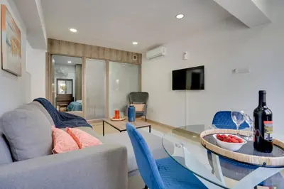 a living room with a couch and a glass table at Atlantis Apartments 50m from Makenzy seafront in Larnaka